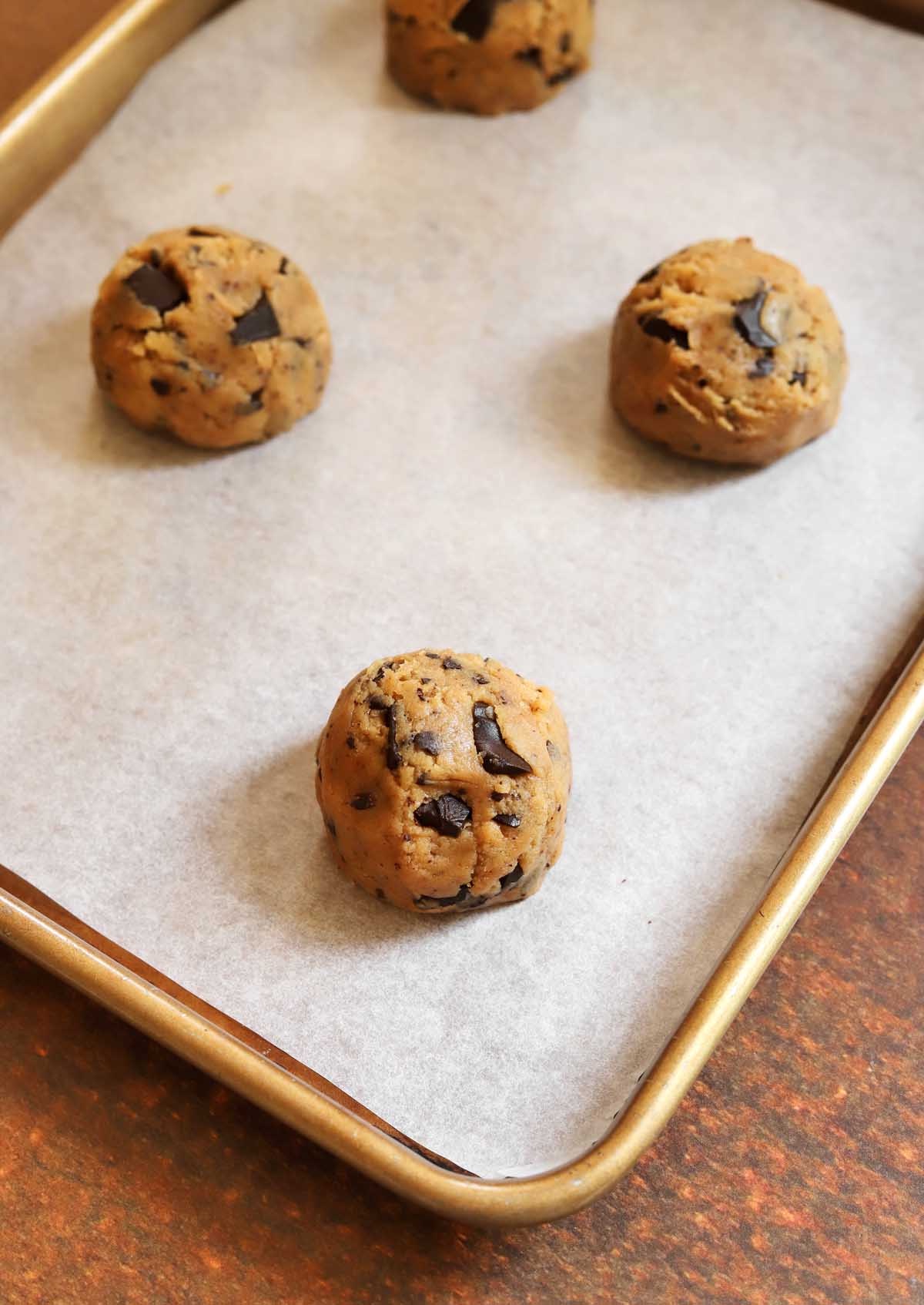 Portioned cookie dough balls on baking sheet