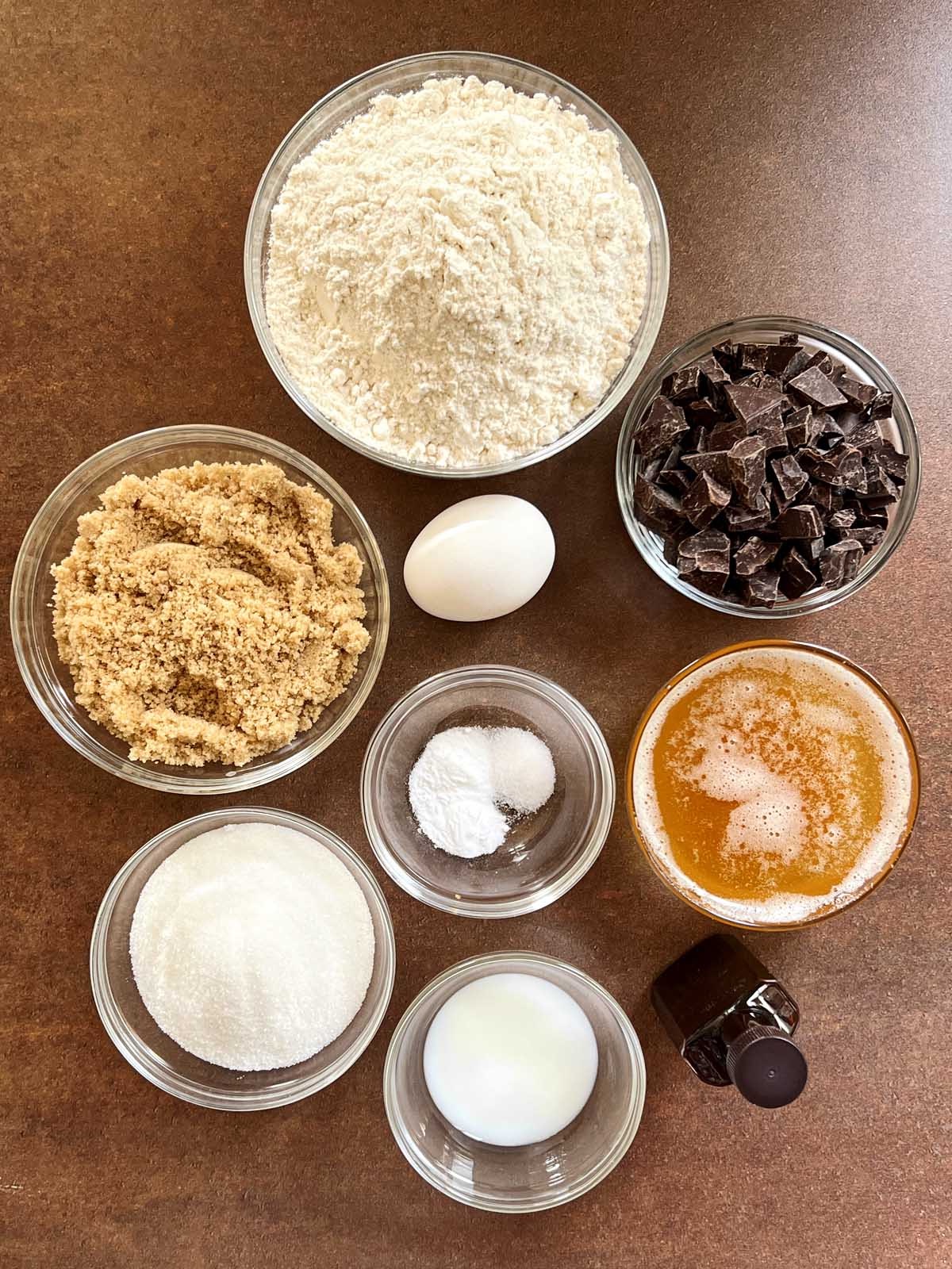 Flat lay of ingredients including butter, flour, sugars, and chocolate